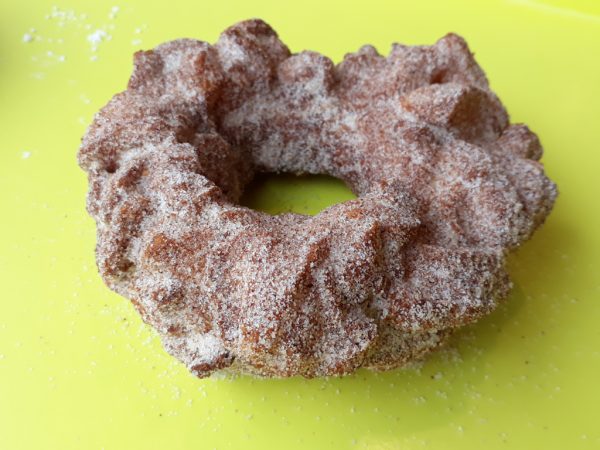 A crispy donut made from small dough pieces joined together, coated in autumn spice sugar.