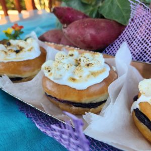 A Thanksgiving donut filled with purple yam jam, topped with marshmallows that are lightly torched for a roasted finish. The donut combines the creamy sweetness of purple yam with the toasty flavor of marshmallows.