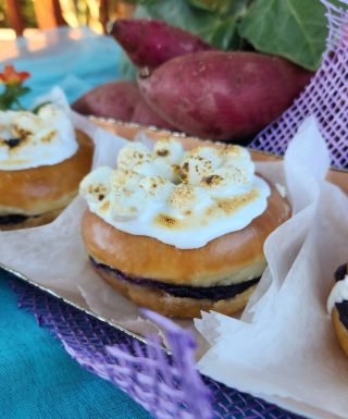 A Thanksgiving donut filled with purple yam jam, topped with marshmallows that are lightly torched for a roasted finish. The donut combines the creamy sweetness of purple yam with the toasty flavor of marshmallows.